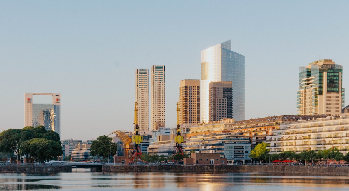 Concrete residential tower silhouetted against the Río de la Plata.